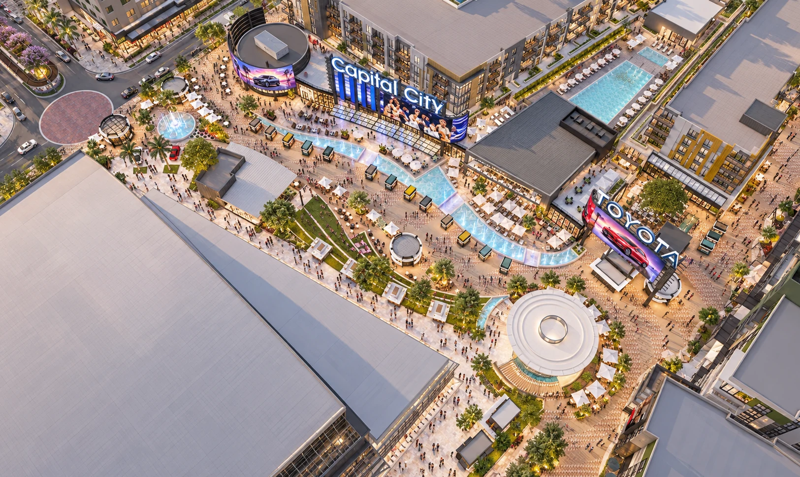 Aerial view of the Plaza: Toyota Arena to the south-west, the round venues, the water feature and the patios, with people moving in from every side toward the Plaza.